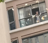 China Woman Throws Money From Apartment in Guangdong