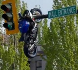 British Columbia Accident Bike crashes into car hangs on traffic light