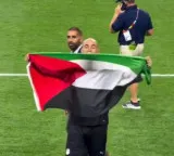 Egypt coach raises Palestinian flag after his side's first knockout win at a FIFA WC