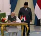 PM Modi signs guestbook upon meeting Indonesian Prez Subianto at Istana Merdeka