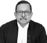 Justice Ujjal Bhuyan Routine activities are being treated as crimes says Supreme Court Judge