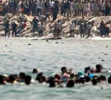 60000 migrants surge into Spain and return within hours