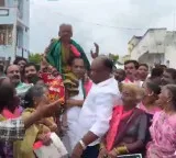 Malla Reddy dances with elderly woman on his shoulders viral video