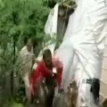 Locals rush to loot liquor bottles after a truck carrying it overturned in Kawardha