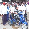 Telangana Minister Niranjan Reddy helps a handicapped person
