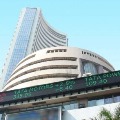 Sensex closes 879 points high