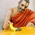 Chinna Jeeyar Swamy feeds a tortoise in his Ashram