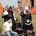 Youth held waving saffron flags at Taj Mahal