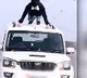 Man does push ups on roof of moving car in viral video