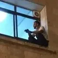 Palestinian climbs wall to see mom through window before she dies of COVID