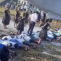 Chinese ambassador to Kiribati pictured walking across the backs of people