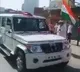 People shower flowers at police vehicles in Meerut