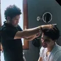 Sachin turns hairstylist for his son
