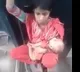 Woman with child sitting on train compartment link as police officer felt emotional